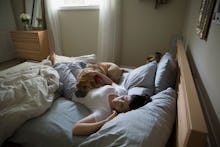 A man lying on the bed with his dog