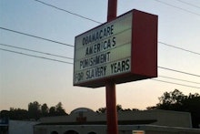 Billboard with "Obamacare America's punishment of slavery years" text
