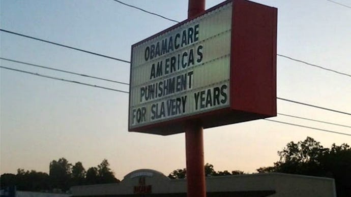 Billboard with "Obamacare America's punishment of slavery years" text