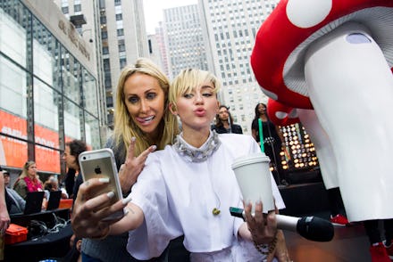Miley Cyrus and her mom taking a selfie, exposing themselves to the government to collect data, as m...