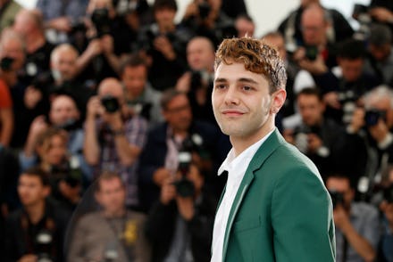 Xavier Dolan Canadian filmmaker in a green suit in cannes