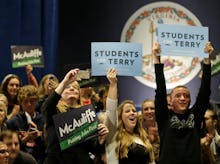 People standing in a group holding a sign that reads students for terry