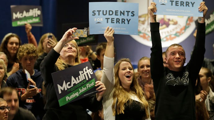 People standing in a group holding a sign that reads students for terry