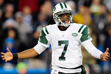 Jets Quarterback Geno Smith with his arms outstretched during a game