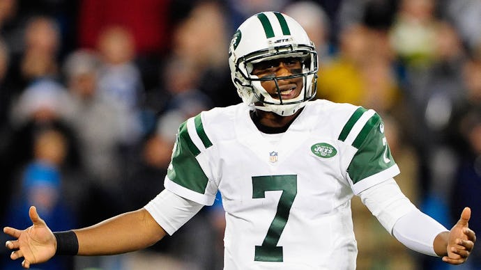 Jets Quarterback Geno Smith with his arms outstretched during a game