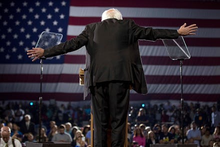 Bernie Sanders bowing in front of a large audience