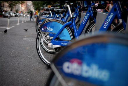 Citi bikes parked and secured next to each other on the sidewalk in new york