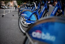 Citi bikes parked and secured next to each other on the sidewalk in new york