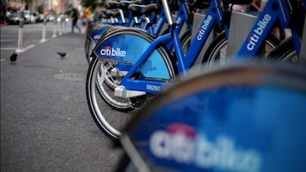 Citi bikes parked and secured next to each other on the sidewalk in new york