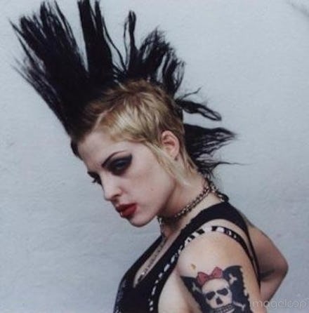 A woman with a mohawk hairstyle, with dark makeup and punk clothes
