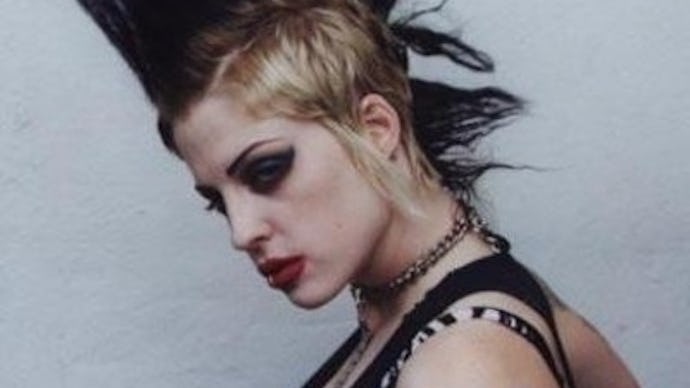A woman with a mohawk hairstyle, with dark makeup and punk clothes