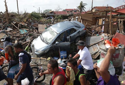 A car and houses and ruin in the Typhoon Haiyan's aftermath