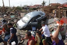 A car and houses and ruin in the Typhoon Haiyan's aftermath