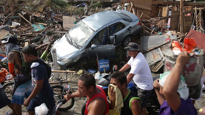 A car and houses and ruin in the Typhoon Haiyan's aftermath