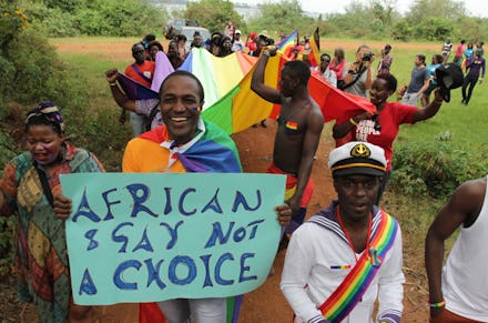 A group of people walking in a protest against Uganda's terrible new anti-gay law