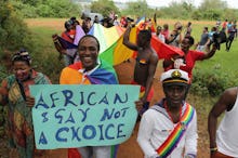 A group of people walking in a protest against Uganda's terrible new anti-gay law