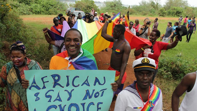 A group of people walking in a protest against Uganda's terrible new anti-gay law