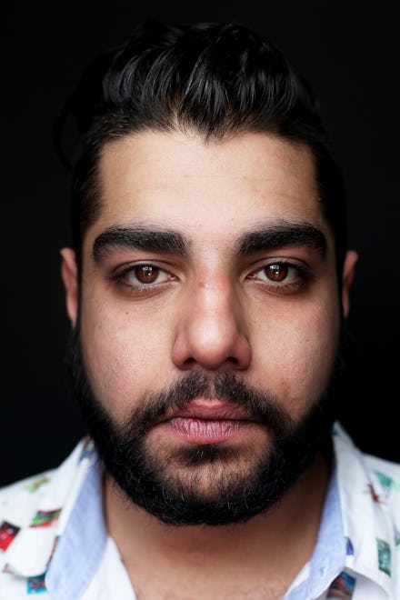 A close-up portrait of Heems, the most exciting new name in hip-hop in a white-and-blue shirt