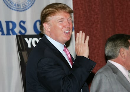Donald Trump smiling and waving and journalists in a black suit, white shirt and a red tie