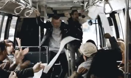 Mackelmore and Ryan Lewis getting on to a bus with people applauding them