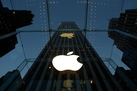 The reflection of a building with the Apple logo on it