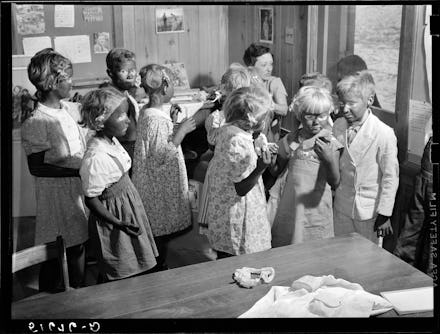 A black and white photo of children in Blackface