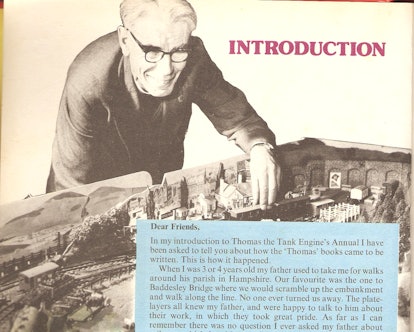 Rev. Wilbert Awdry playing with train toy
