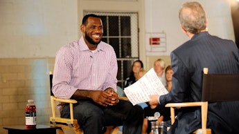 LeBron James in white and red stripped shirt sitting in a chair during his interview with Jim Gray