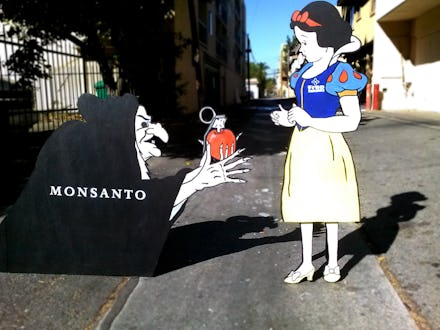 Cardboard cutouts of an evil witch giving an apple to Snow White, and her being unsure whether to ta...