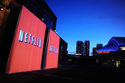 A city skyline with two billboards with the netflix logo on them