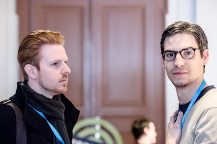 Two startup creators stand next to each other at a tech conference