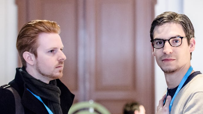 Two startup creators stand next to each other at a tech conference