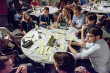 A group of 20-somethings sitting around a table having an in-depth discussion