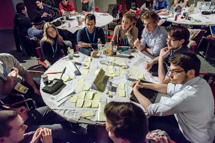A group of 20-somethings sitting around a table having an in-depth discussion