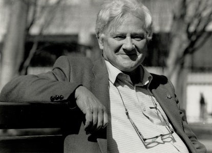 Black and white photograph of Richard Adams sitting on the bench