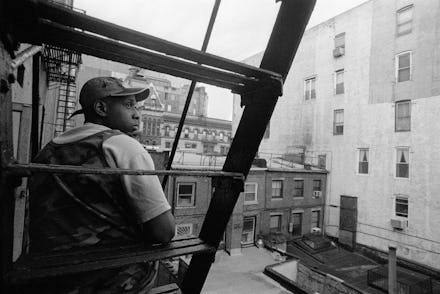 A man sitting on metal stairs outside