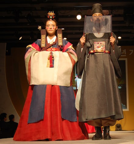 Oriental dressed boy and girl on a catwalk