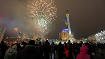 Ukraine's Maidan square filled with fireworks and groups of people
