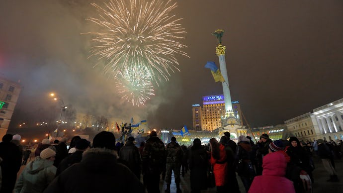 Ukraine's Maidan square filled with fireworks and groups of people