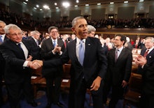 Barack Obama during the State of the Union with a group of men behind him