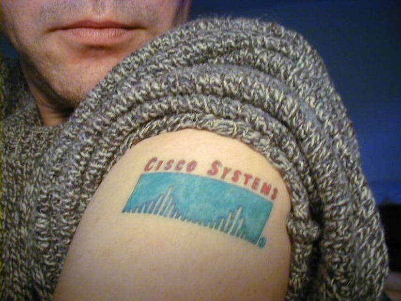 A person with a Cisco Systems tattoo on their arm
