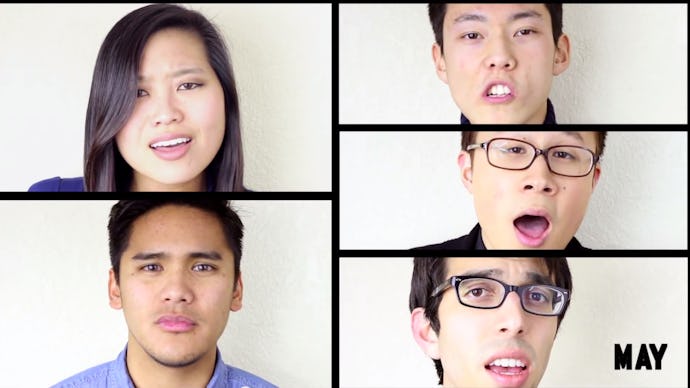 A group of people in front of a white background singing an a cappella medley