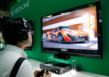A man playing a racing XBOX game at a shop