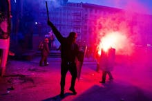 Protesters in Ukraine holding torches and shields