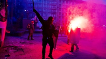 Protesters in Ukraine holding torches and shields