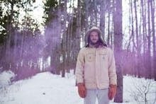 Justin Vernon in a forest covered in snow 