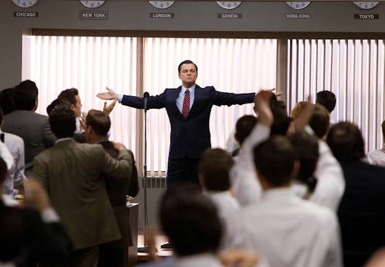 Leonardo DiCaprio with his arms stretched out in the wolf of wallstreet