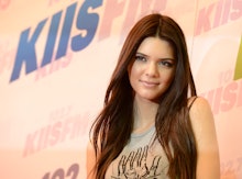 Kendall Jenner when she was younger, with light brown hair and a tank top