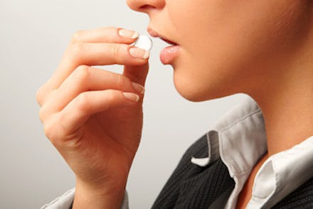 A woman taking an abortion pill