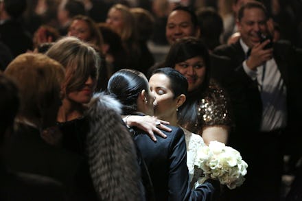 Two women kissing at Macklemore Mass Wedding